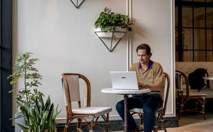 Man sitting and working on laptop.